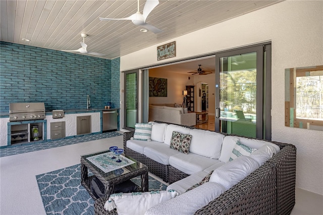 view of patio / terrace featuring sink, exterior kitchen, grilling area, ceiling fan, and an outdoor living space