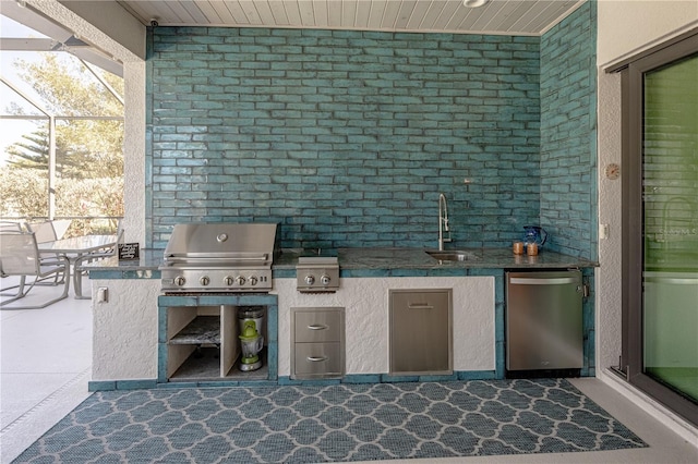 view of patio with an outdoor kitchen, sink, grilling area, and glass enclosure