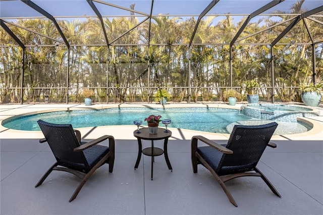 view of swimming pool with an in ground hot tub, a lanai, and a patio area