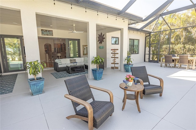 view of patio with ceiling fan, outdoor lounge area, and glass enclosure