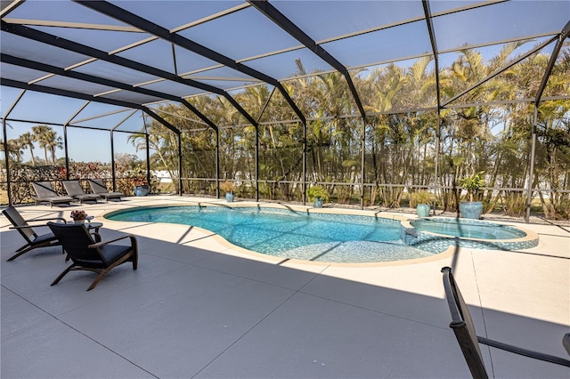 view of pool with an in ground hot tub, a lanai, and a patio area