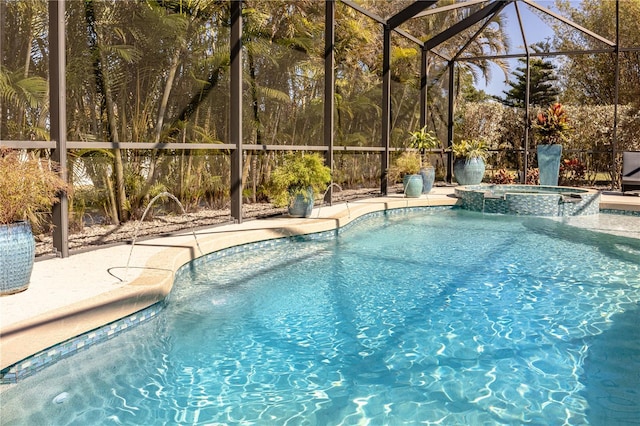 view of pool featuring a patio, glass enclosure, and an in ground hot tub