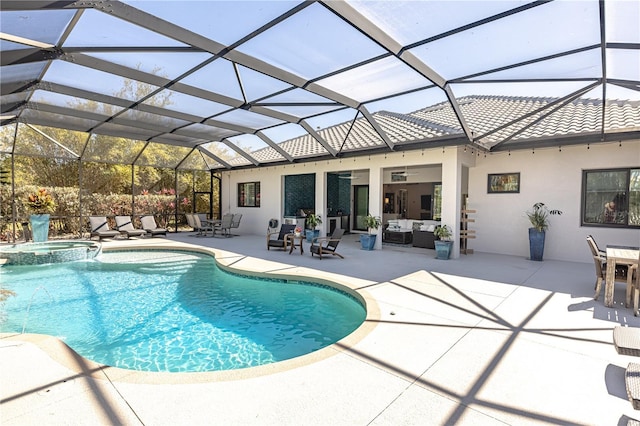 view of pool featuring ceiling fan, outdoor lounge area, a patio, glass enclosure, and an in ground hot tub