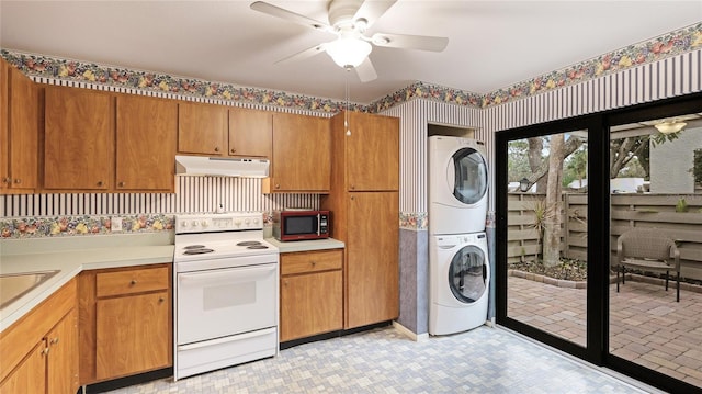 kitchen featuring ceiling fan, stacked washer / drying machine, sink, and white range with electric stovetop