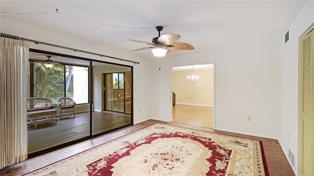 interior space featuring a textured ceiling, light tile patterned floors, access to outside, a closet, and ceiling fan with notable chandelier