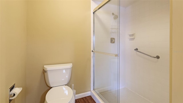 bathroom with toilet and walk in shower