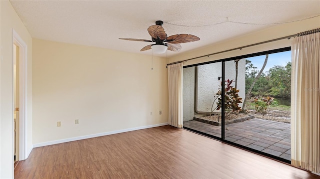 unfurnished room with ceiling fan, hardwood / wood-style floors, and a textured ceiling