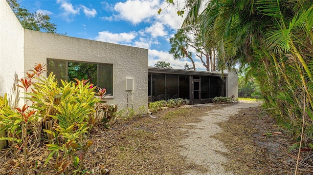 view of side of property with a sunroom