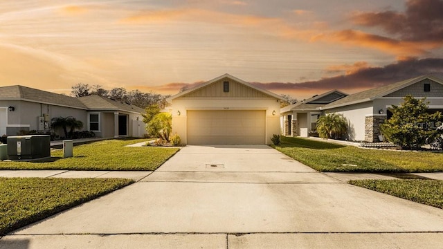 view of front of home featuring a garage and a lawn