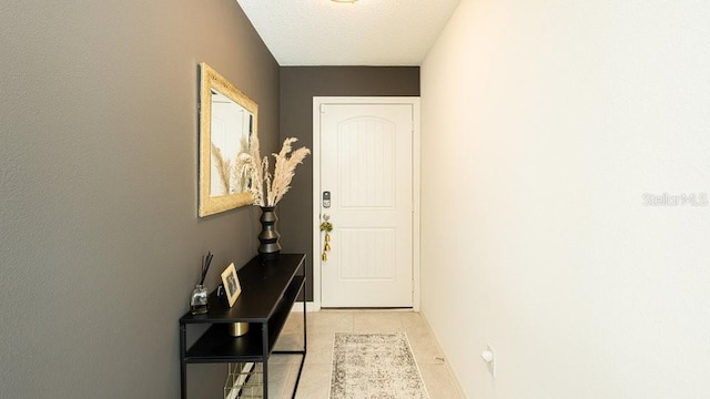 doorway to outside with light tile patterned floors