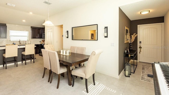 dining space with visible vents, baseboards, and light tile patterned flooring