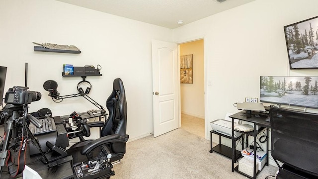 home office with baseboards and light colored carpet