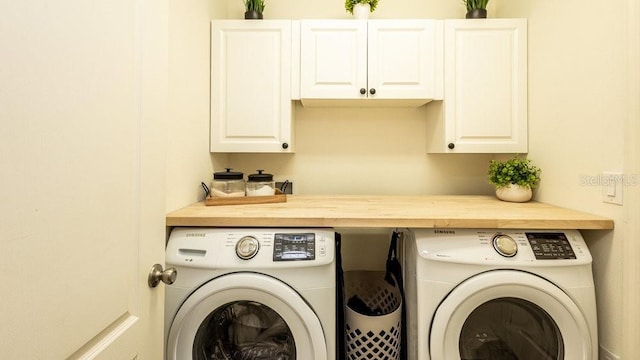 laundry area with cabinet space and independent washer and dryer