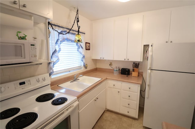 kitchen with sink, white cabinets, pendant lighting, white appliances, and backsplash