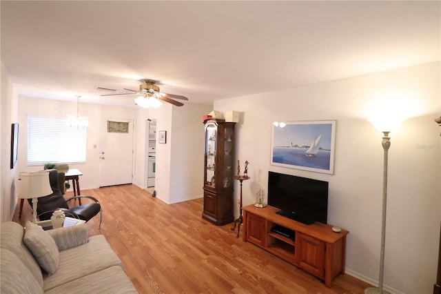 living room featuring light hardwood / wood-style flooring and ceiling fan