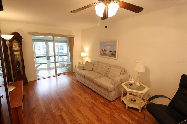 living room with hardwood / wood-style floors and ceiling fan