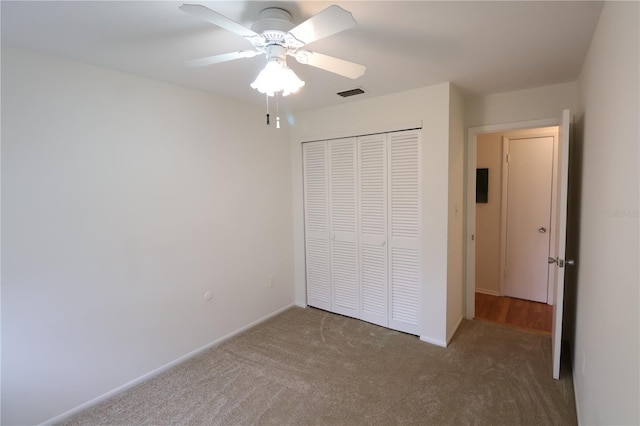 unfurnished bedroom featuring a closet, ceiling fan, and carpet