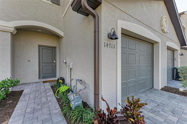 doorway to property featuring a garage