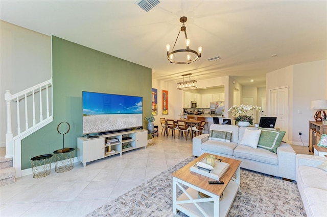 tiled living room featuring a notable chandelier