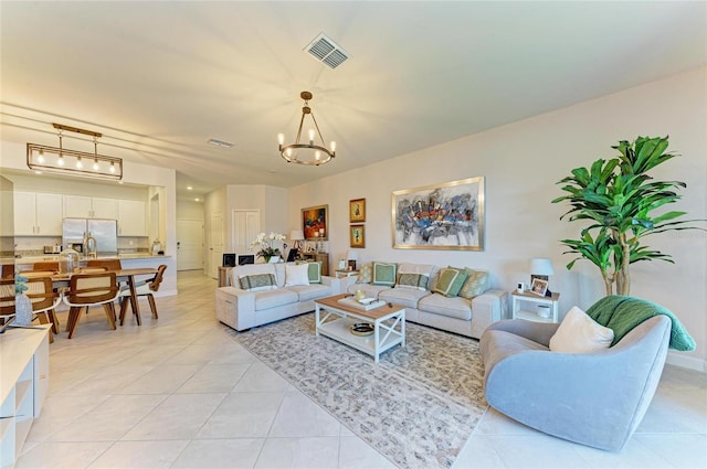 tiled living room featuring a notable chandelier