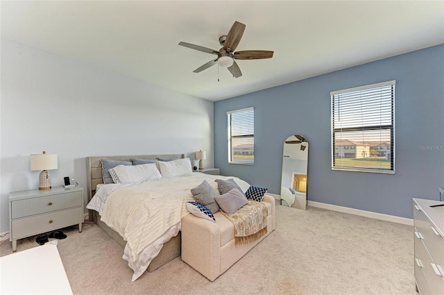 bedroom featuring ceiling fan and light carpet