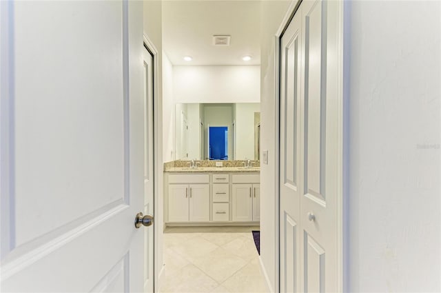 bathroom with tile patterned flooring and vanity