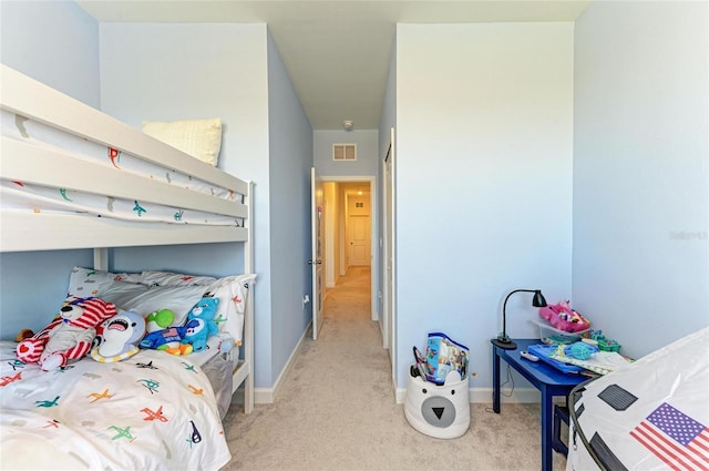 bedroom featuring light carpet