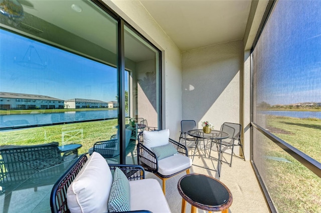 sunroom / solarium with a water view