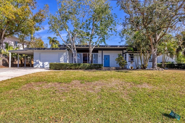 ranch-style house featuring a carport, a garage, and a front yard