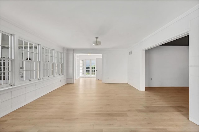 unfurnished room featuring crown molding and light hardwood / wood-style flooring