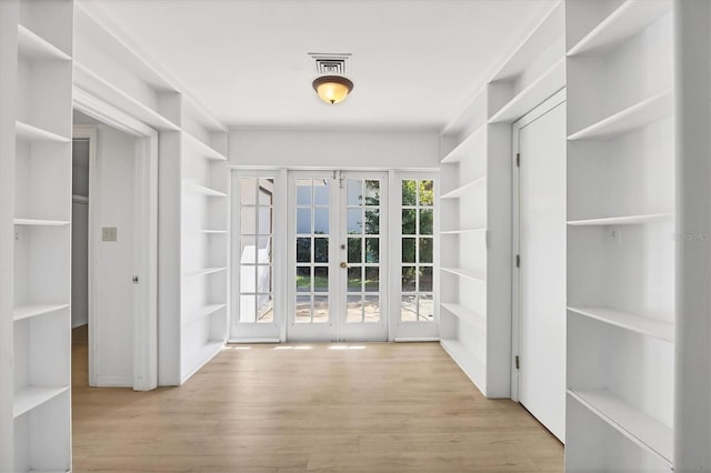 interior space with light hardwood / wood-style floors and french doors