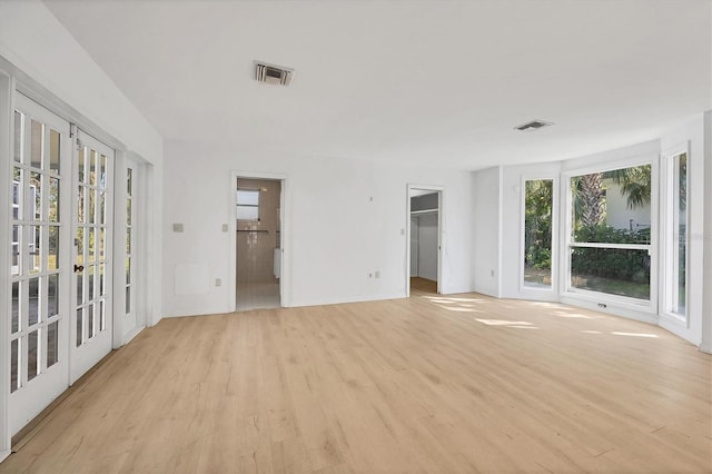 unfurnished room with french doors and light hardwood / wood-style floors