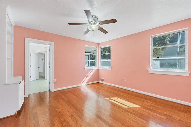 unfurnished room with ceiling fan and light hardwood / wood-style floors