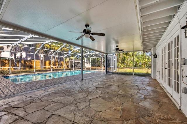 view of swimming pool with a lanai, a patio area, ceiling fan, and french doors