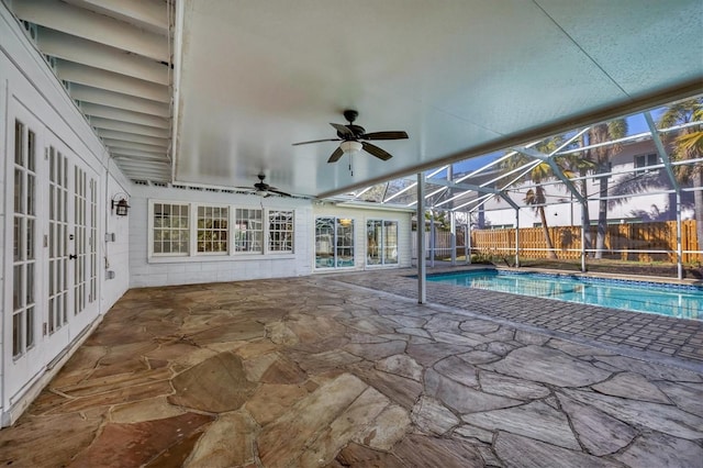 view of swimming pool featuring a patio, a lanai, ceiling fan, and french doors