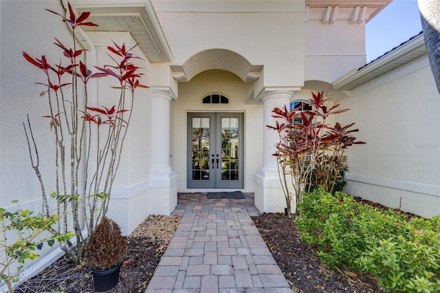 doorway to property with french doors and stucco siding