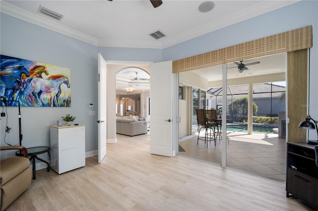 interior space featuring ceiling fan, light wood-type flooring, and visible vents