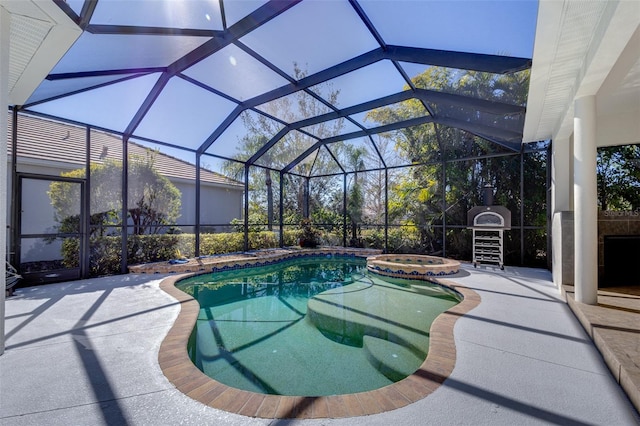 view of swimming pool featuring grilling area, a patio area, a lanai, and a pool with connected hot tub
