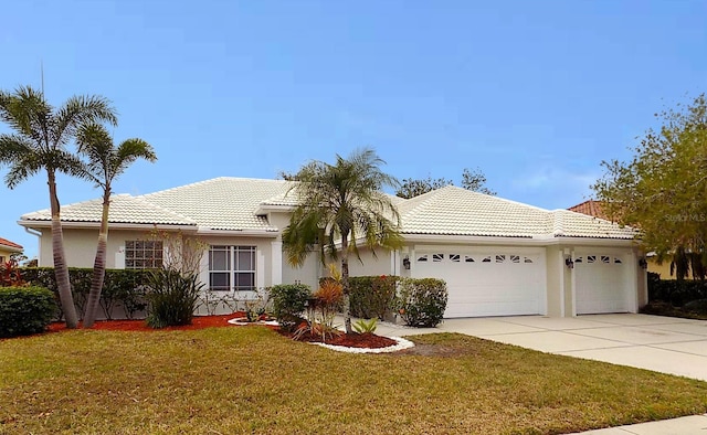 view of front of property featuring a garage and a front lawn