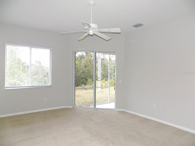 unfurnished room featuring carpet, a healthy amount of sunlight, and ceiling fan