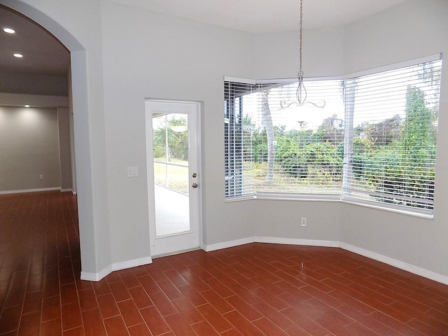 unfurnished dining area featuring dark hardwood / wood-style flooring and a healthy amount of sunlight