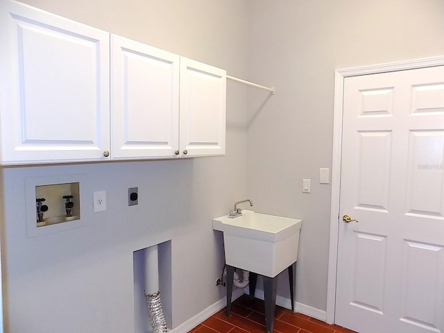 washroom with electric dryer hookup, washer hookup, and cabinets