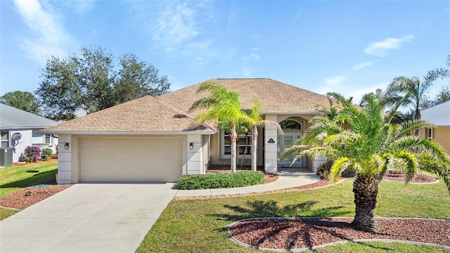 ranch-style house with a garage, a front yard, driveway, and stucco siding