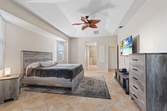 bedroom featuring a ceiling fan, a raised ceiling, and visible vents