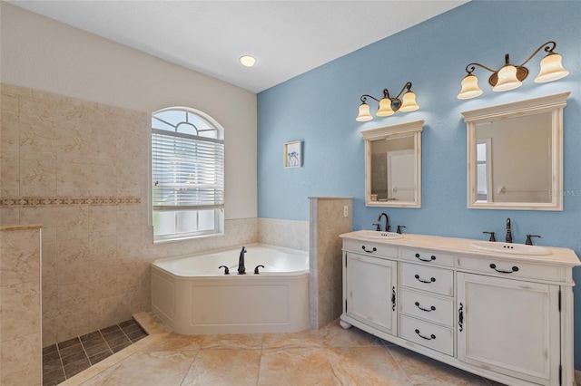 bathroom featuring a garden tub, double vanity, and a sink