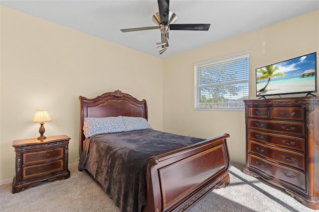 bedroom featuring light carpet and ceiling fan