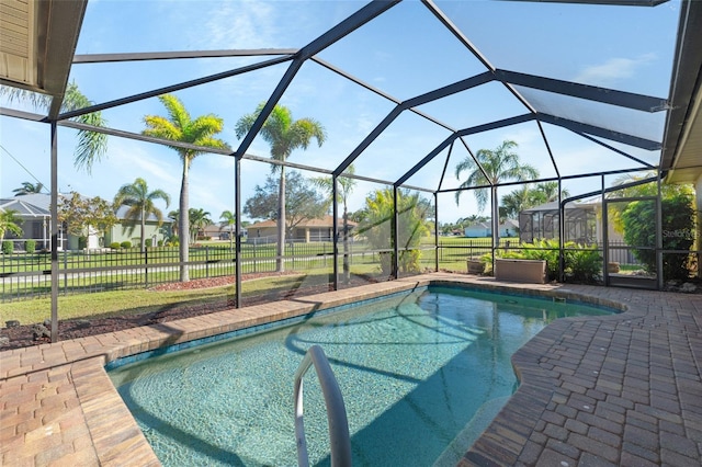 view of swimming pool with a fenced in pool, a patio, fence, a residential view, and a lanai