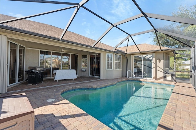 outdoor pool featuring a lanai, a grill, ceiling fan, and a patio