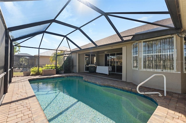 outdoor pool with a lanai and a patio area