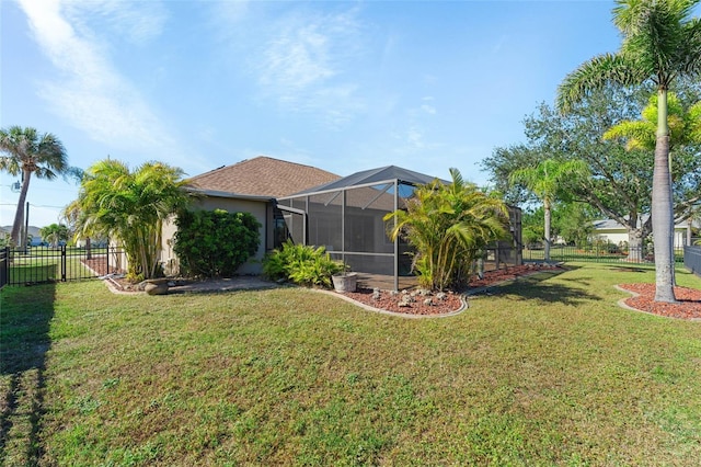 view of yard with fence and a lanai